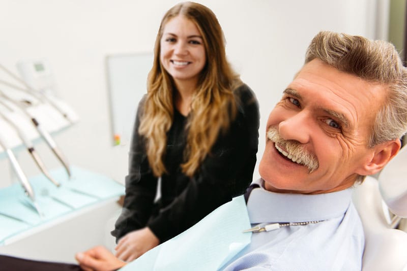 a man smiling after receiving a dental treatment